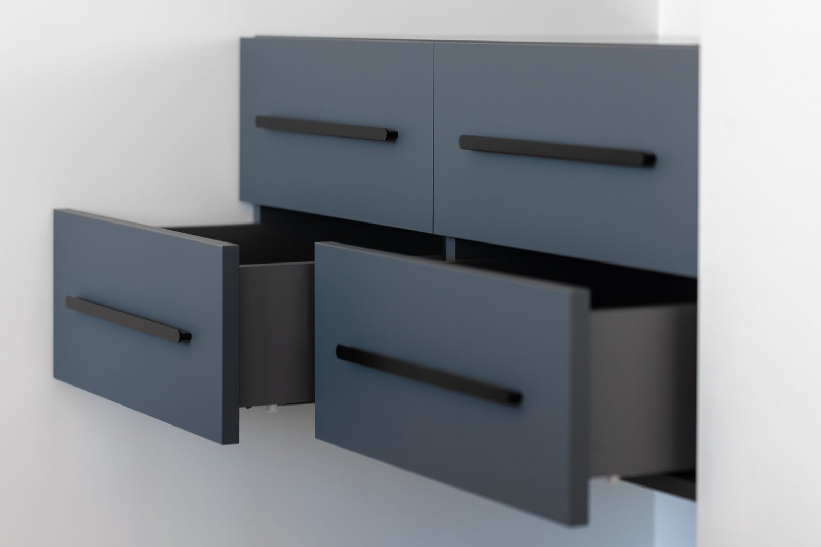 Blue floating cabinet with open drawers